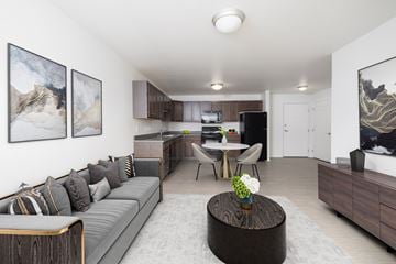 Sioux Falls apartment for rent - A living room with a grey couch and a coffee table in the middle.