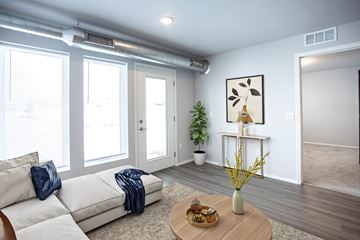 Waukee townhouse for rent - A living room with a white couch and a wooden coffee table.