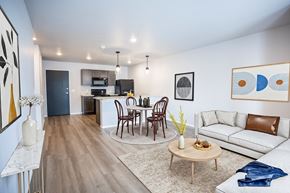 Waukee townhouse for rent - A modern living room with a dining table set up in the middle.