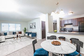 Sioux Falls apartment for rent - A modern living room with a dining table set for two.
