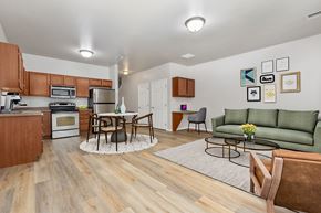 Sioux Falls townhouse for rent - A kitchen with a dining table and chairs in the middle of the room.