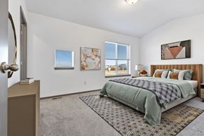 Harrisburg townhouse for rent - A bedroom with a bed, a dresser, and a window.