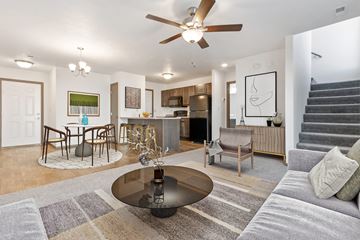 Harrisburg townhouse for rent - A modern living room with a grey sofa and a glass coffee table.