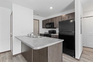 Rapid City townhouse for rent - a kitchen with a sink and a refrigerator