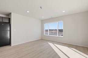 Rapid City apartment for rent - A spacious room with a large window overlooking a construction site.