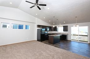 Sioux Falls apartment for rent - a living room with a kitchen and a ceiling fan