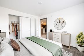 Sioux Falls townhouse for rent - A bedroom with a bed, dresser, and mirror.