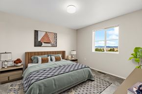 Rapid City apartment for rent - A bedroom with a bed, nightstand, and window.