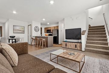 North Sioux City townhouse for rent - A living room with a brown couch and a wooden coffee table.