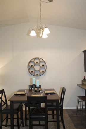 Sioux Falls townhouse for rent - a dining room with a table and chairs and a mirror on the wall