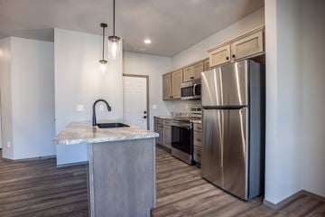 Sioux Falls townhouse for rent - a kitchen with stainless steel appliances and a marble counter top
