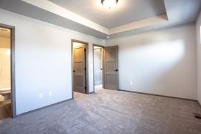 Sioux Falls townhouse for rent - an empty living room with two doors and a white wall
