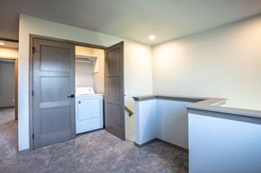 Sioux Falls townhouse for rent - a laundry room with a washer and dryer and a door to a bathroom