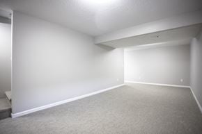 Sioux Falls townhouse for rent - A spacious room with carpeted floor and white walls.