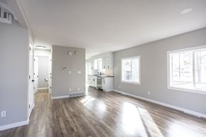Sioux Falls townhouse for rent - A spacious room with wooden floors and white walls.