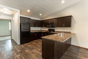 Harrisburg townhouse for rent - a kitchen with black appliances and a granite counter top