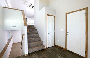Sioux Falls apartment for rent - the entryway of a house with stairs and a white door