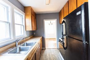 Sioux Falls apartment for rent - a kitchen with wooden cabinets and a black refrigerator and sink
