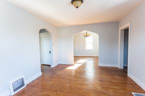 Sioux Falls apartment for rent - an empty living room with a hard wood floor and blue walls