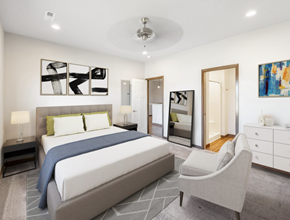 Brandon townhouse for rent - a white bedroom with a large bed and a chair