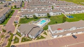 Sioux Falls townhouse for rent - A swimming pool is surrounded by houses in a residential area.