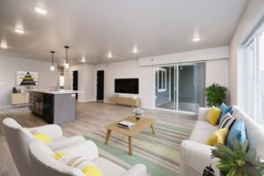 Sioux Falls apartment for rent - A living room with a white sofa, a wooden coffee table, and a TV.