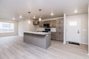 Sioux Falls apartment for rent - A kitchen with a large island and wooden floors.