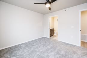 Rock Valley apartment for rent - A room with a ceiling fan and carpeted floor.