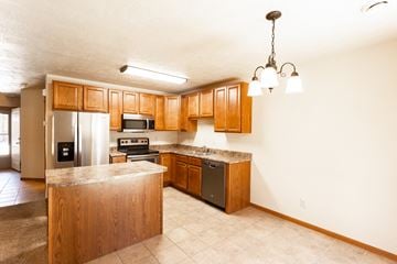Sioux Falls townhouse for rent - a kitchen with wooden cabinets and stainless steel appliances