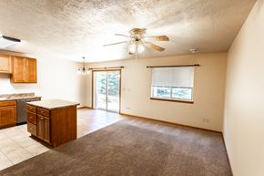 Sioux Falls townhouse for rent - an empty kitchen and living room with a ceiling fan