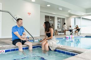 Sioux Falls apartment for rent - a man and a woman sitting in a swimming pool
