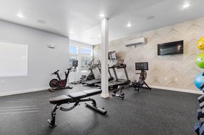 Sioux Falls apartment for rent - A spacious home gym with a variety of exercise equipment.