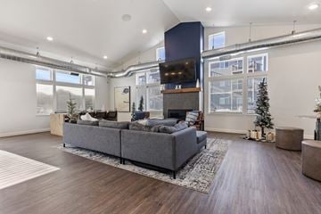 Harrisburg apartment for rent - A modern living room with a grey sofa and a wooden floor.