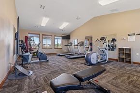 Sioux Falls townhouse for rent - A gym with a variety of equipment including treadmills, weights, and exercise machines.