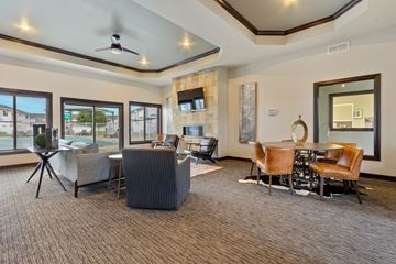 Sioux Falls townhouse for rent - A living room with a grey carpet and brown chairs.