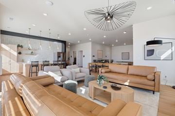 Rapid City apartment for rent - A modern living room with a large sectional sofa and a coffee table.