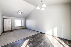 Sioux Falls townhouse for rent - A spacious room with a ceiling fan and a door.