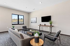 Rapid City townhouse for rent - a living room with a couch and chairs and a tv