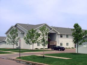 Sioux Falls apartment for rent - a large white building with a car parked in front of it
