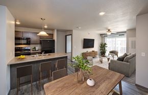 Grimes townhouse for rent - A modern kitchen with a bar and a dining table.