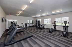 Grimes townhouse for rent - A gym with treadmills, weights, and exercise machines.