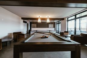 Sioux Falls apartment for rent - A pool table is in the middle of a room with a couch and a chair.