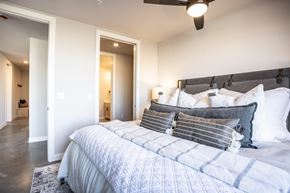 Sioux Falls apartment for rent - A bedroom with a large bed and a ceiling fan.