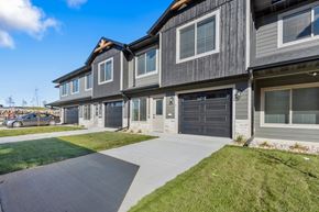 Brandon townhouse for rent - A modern two-story house with a grey exterior and a black garage door.