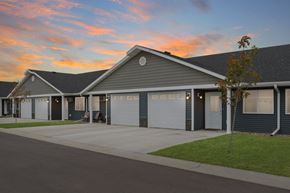 Sioux Falls townhouse for rent - the front of a house with garage doors at sunset