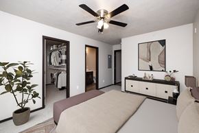 Tea townhouse for rent - A bedroom with a bed, dresser, and mirror.