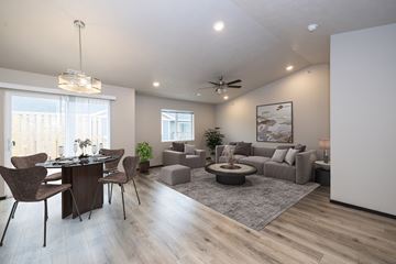 Tea townhouse for rent - A modern living room with a dining table and chairs.