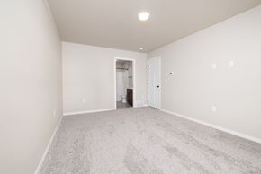 Sioux Falls townhouse for rent - A spacious room with carpeted floor and white walls.