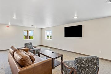 Rapid City apartment for rent - a living room with a couch and chairs and a television