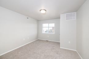 Sioux Falls apartment for rent - A spacious, empty room with a window and carpeted floor.